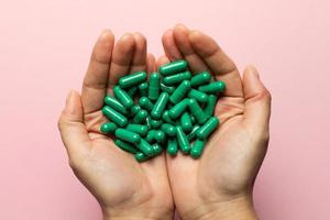 Rhodiola rosea capsules held in hands. Health and happy life concept. photo