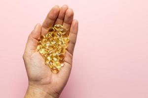 D3 K2 capsules on the hands. Strengthening immunity and care for health. photo