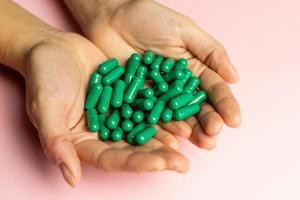 Rhodiola rosea capsules held in hands. Health and happy life concept. photo