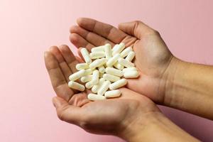 White zinc tablets in the hands. Care for health and life. photo