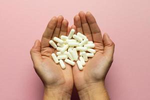 White zinc tablets in the hands. Care for health and life. photo