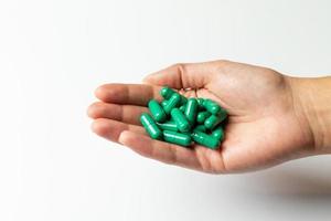 Rhodiola rosea capsules on a female hand. photo
