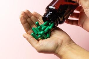 Rhodiola rosea capsules poured on the hand from the package. photo
