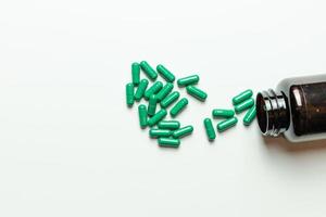 Green pills with packaging on a white background. photo