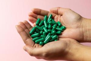 Rhodiola rosea capsules held in hands. Health and happy life concept. photo