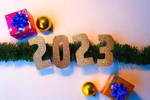 Happy New Year 2023. Golden numbers Christmas white background photo