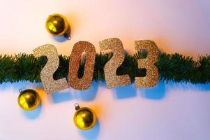 Happy New Year 2023. Golden numbers Christmas white background photo