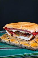 torta mexicana caprichosa grande con milanesa de cerdo, jamón de pierna y queso foto