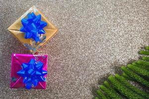 Christmas decorations with spheres gifts and pine needles with space for text and shiny background photo