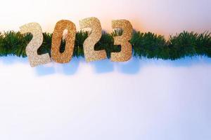 Happy New Year 2023. Golden numbers Christmas white background photo