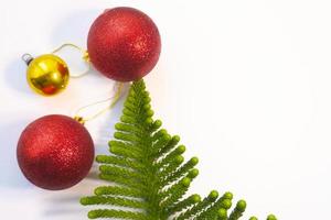 Christmas decorations with spheres gifts and pine needles with space for text and shiny background photo