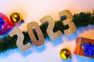 Happy New Year 2023. Golden numbers Christmas white background photo