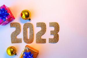 Happy New Year 2023. Golden numbers Christmas white background photo