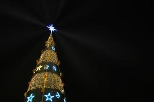 Christmas tree-shaped sparklers on black background photo