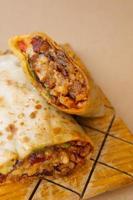 Pastor mexican burrito with meat and hot sauce photo