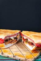 torta mexicana caprichosa grande con milanesa de cerdo, jamón de pierna y queso foto