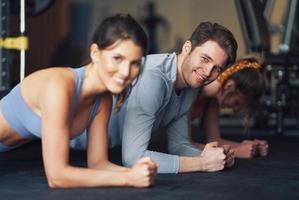 Group of people working out in a gym photo
