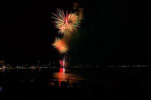 Abstract colored firework background light up the sky with dazzling display photo