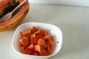 Portrait slices of sweet papaya isolated on wooden background. Healthy living concept photo