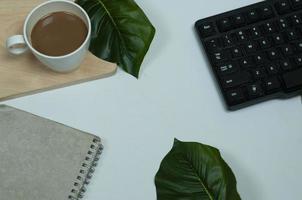 White office desk with a cup of coffee. Concept photo about office desk