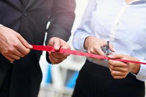 Businesspeople cutting the ribbon photo