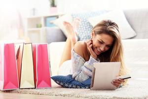 Pretty woman shopping online with credit card photo