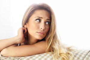 Sad woman resting on sofa photo