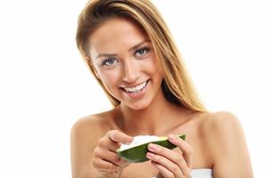 Portrait of attractive adult woman with avocado isolated over white background photo