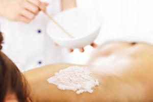 Beautiful woman having exfoliation treatment in spa photo