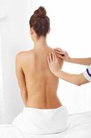 A picture of woman having back therapy photo