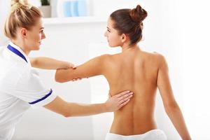 A picture of woman having back therapy photo