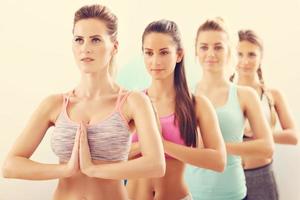 Portrait of female group practising yoga photo