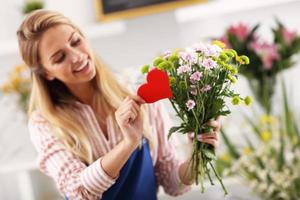 Female florist working in flower shop photo