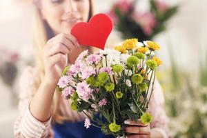 Female florist working in flower shop photo