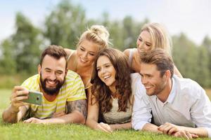 Friends group having fun together on grass photo