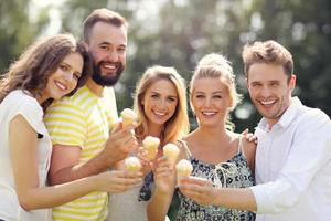 Group of friends eating ice-cream outdoors photo