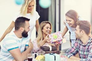 Group of friends having fun at birthday party photo