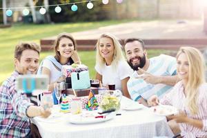 Group of friends having fun at birthday party photo