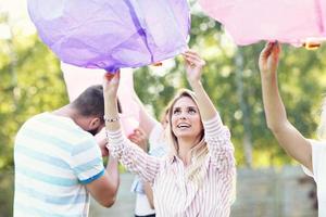 Group of friends floating chinese lanterns photo