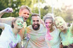 Group of friends having fun at color festival photo