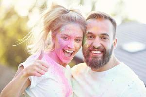 Group of friends having fun at color festival photo