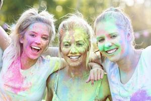 Group of friends having fun at color festival photo