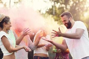 Group of friends having fun at color festival photo