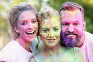 Group of friends having fun at color festival photo