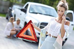 Pretty women having problem with car on the road photo