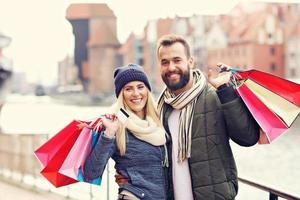 Happy couple shopping in the city photo