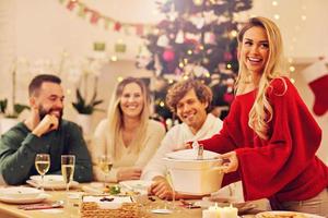 Group of family and friends celebrating Christmas dinner photo