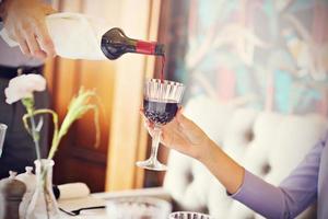 Romantic couple dating in restaurant being served by waiter photo