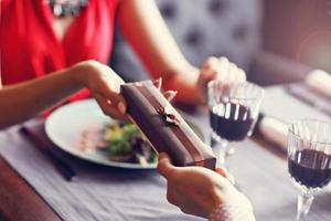 Midsection of romantic couple dating in restaurant photo