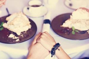 Couple eating romantic Dinner in a gourmet restaurant drinking wine and holding hands photo